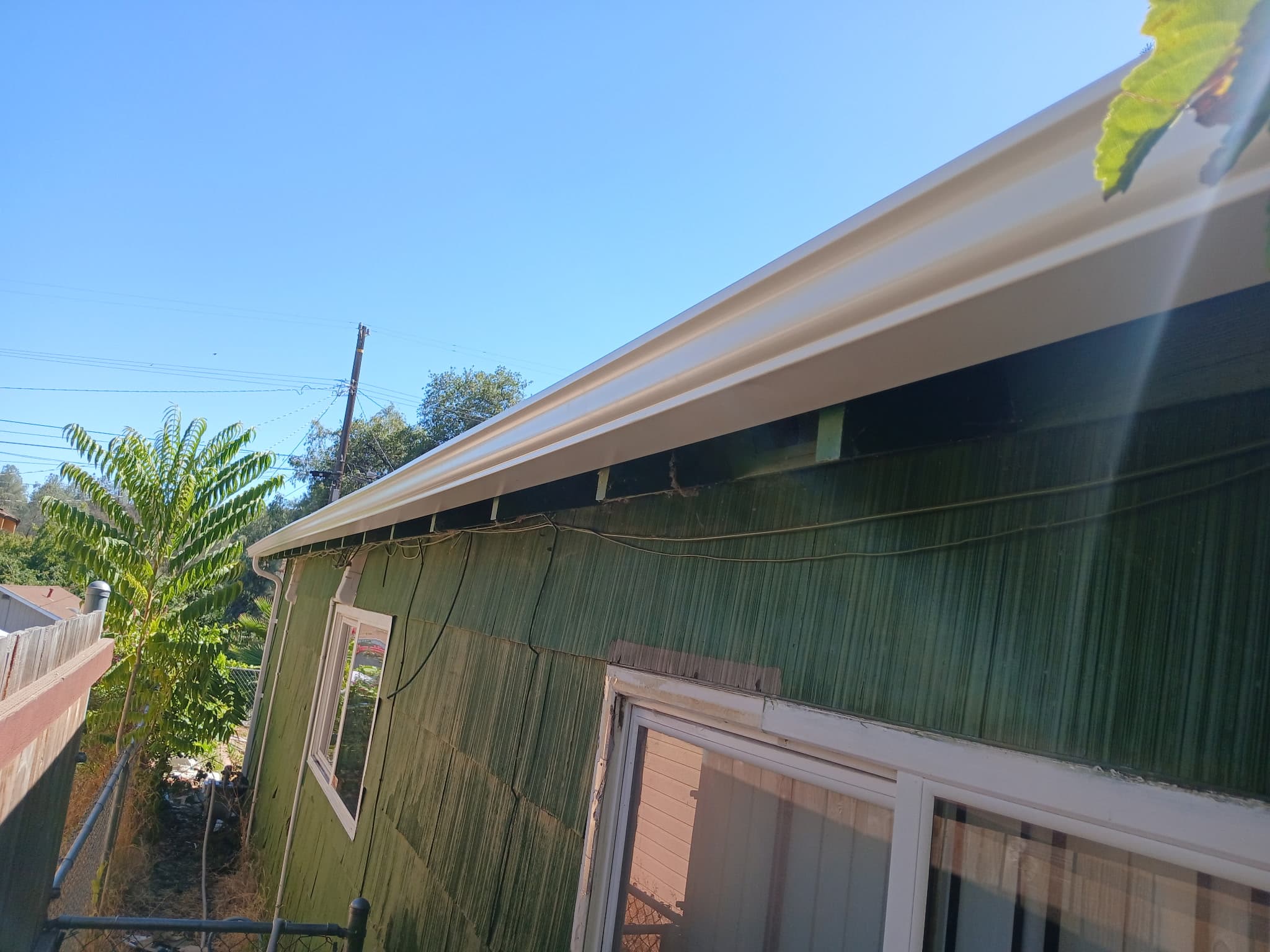 Sage green home with new white seamless gutters in Happy Valley